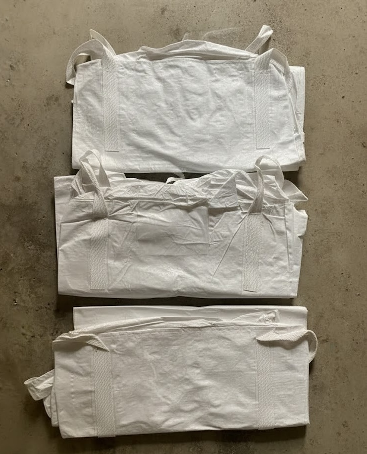 Different grades of folded bulk bags showing quality variations